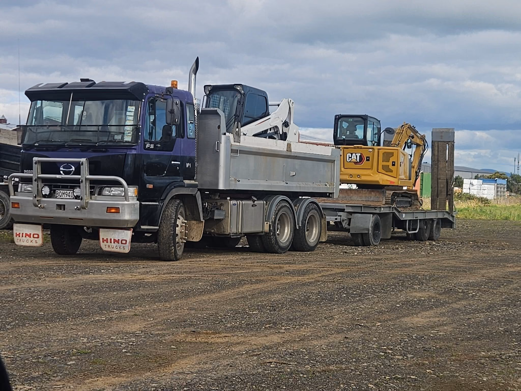 Big Snapper Bobcats tip truck loaded with a bobcat and mini excavator