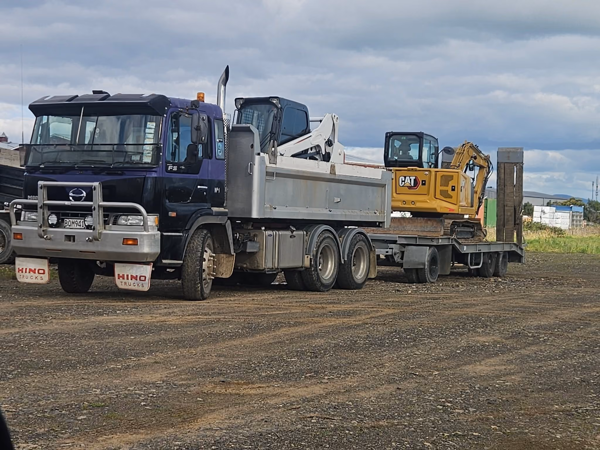 Big Snapper Bobcats tip truck loaded with a bobcat and mini excavator
