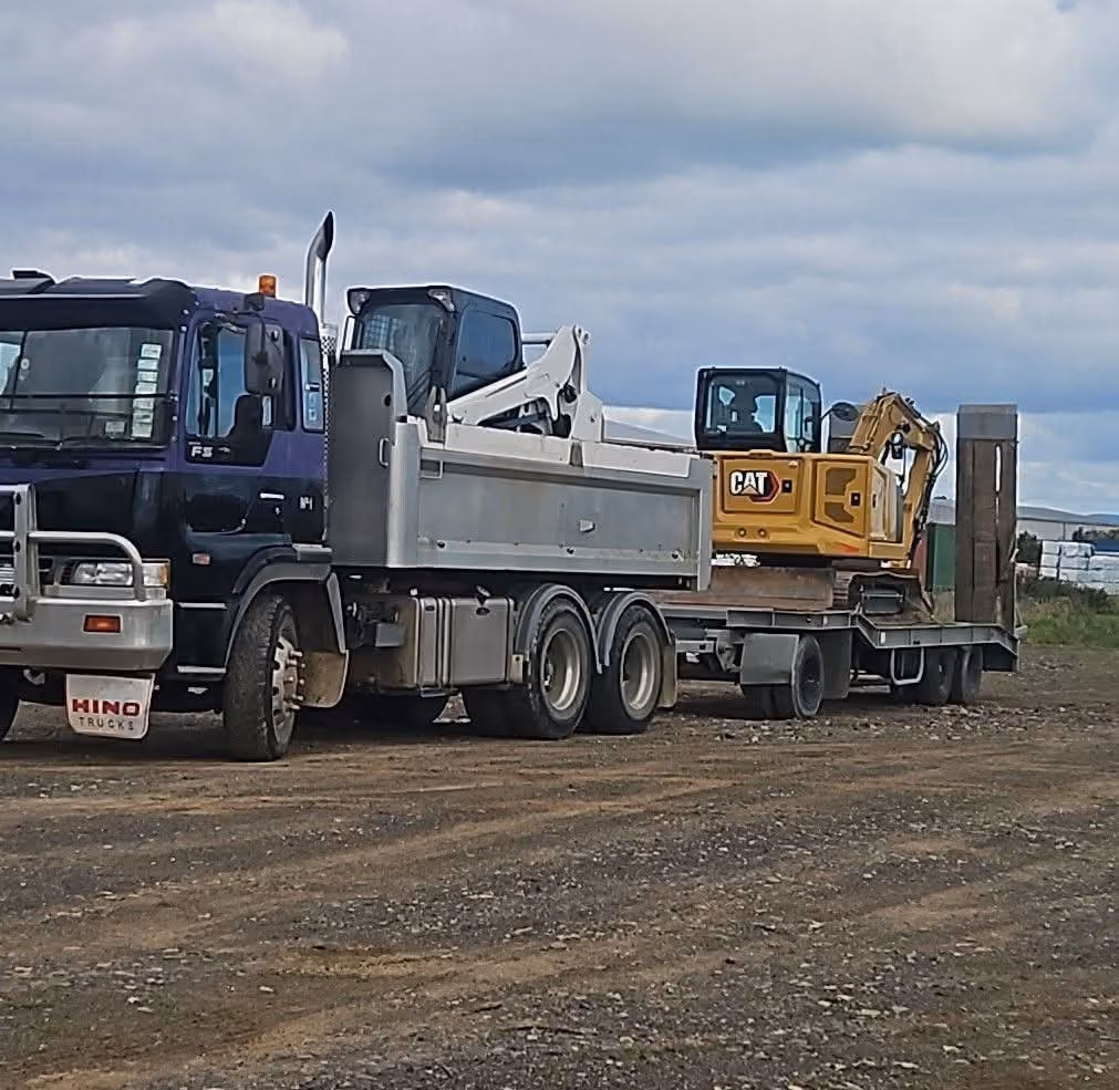 Transporter truck loaded with a Cat digger ready to head to site